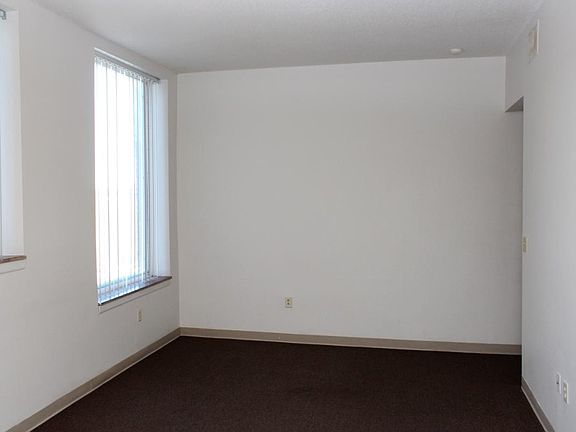 Living area in a Marsh Place 1 BR. Large windows in all the