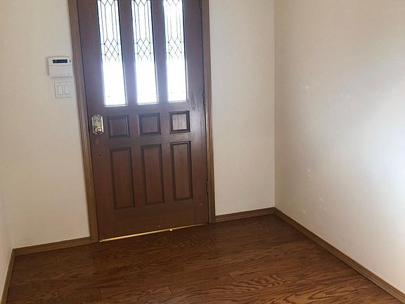 Generous entry-way with pretty leaded glass door. Upgraded wood flooring.