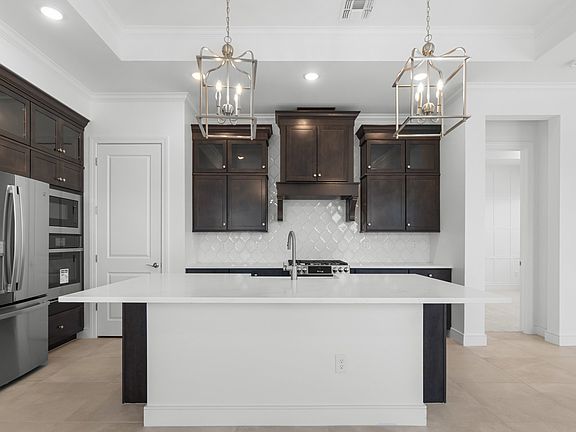 Kitchen with full height tile backsplash
