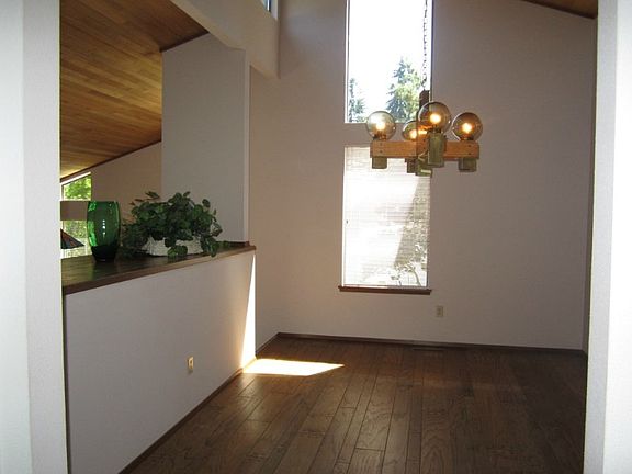 Planked hardwood floors add charm to this generous separate dining area.