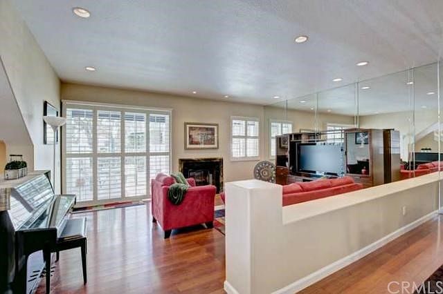 Beautiful entry welcomes you to large living room with recessed lights, sliding glass doors and plan