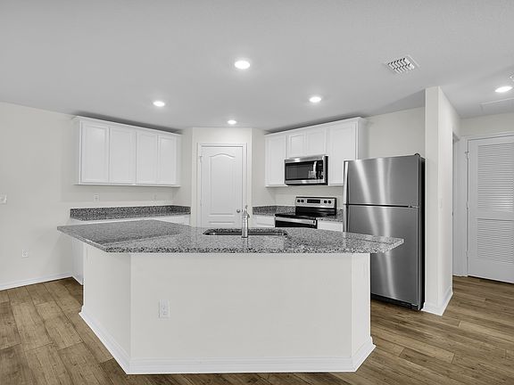 The kitchen has a large island that will be perfect for you and your family to gather around