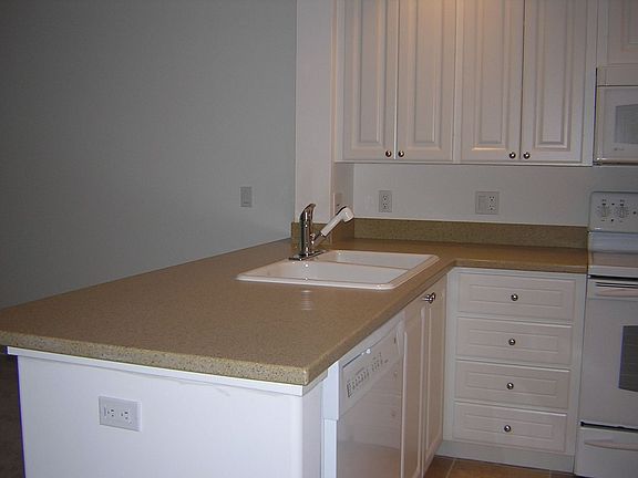 Corian and oversized tile floors in kitchen
