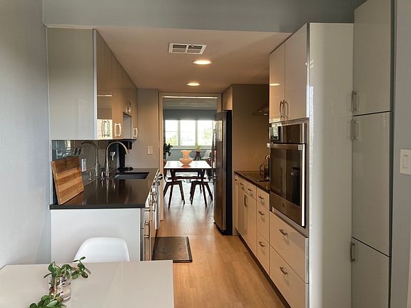 Fully renovated galley kitchen. All dishware and cookware are included. Nice water and sunset views straight through the condo.