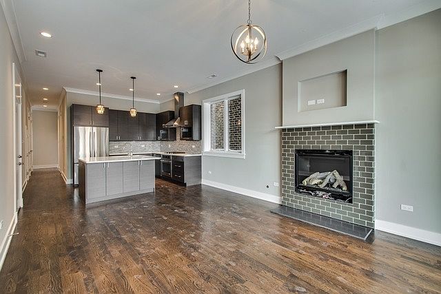 open floor plan with kitchen and living space (Pendant lights in kitchen have been updated)