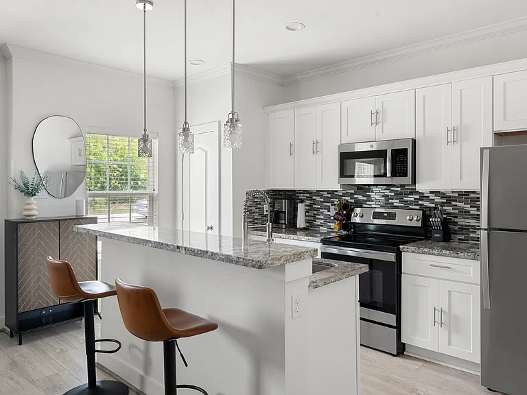 Fully equipped kitchen with granite countertops and stainless steel appliances.