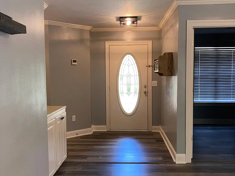 Entry way into living room (office in open door on right side of photo)
