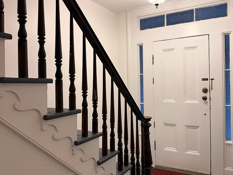 Private front door entrance with elegant staircase.