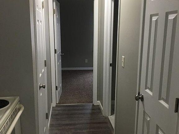Kitchen into the bedroom. Bathroom and basement foor on right. Pantry door on left.