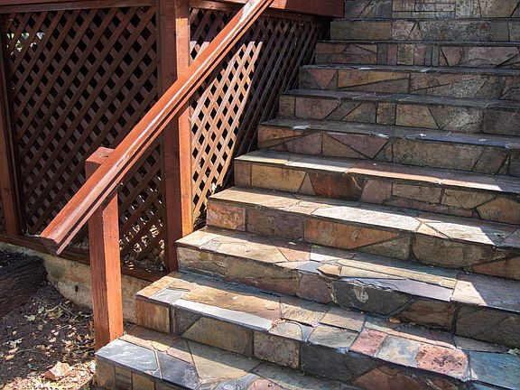Hand-tiled steps up to house.