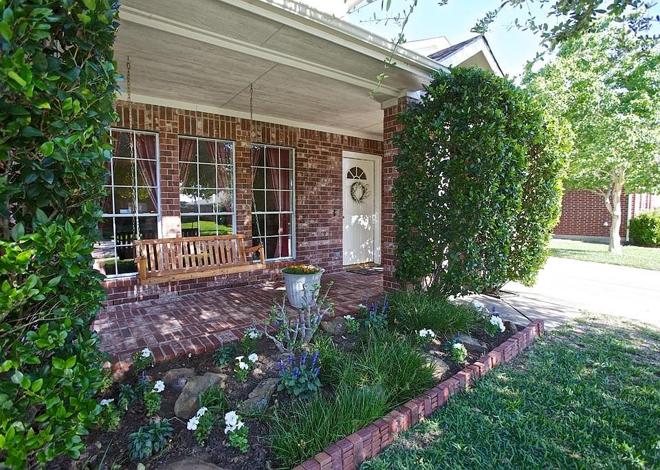 An atmosphere for charm ....This lovely porch welcomes family and guests alike with porch swing, gar