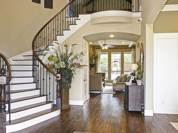 Dynamic curved staircase in foyer