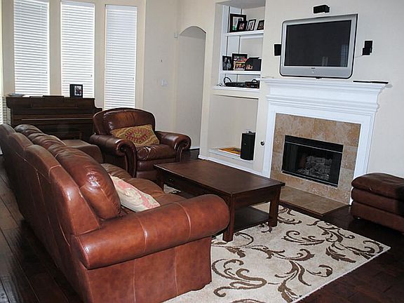 Wander to the back of the house to find the family area, complete with a fireplace and built ins for