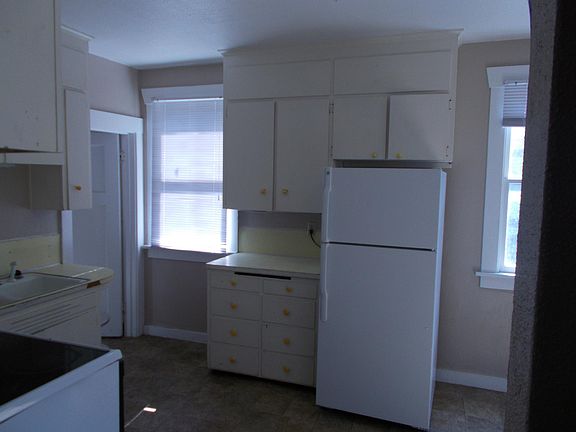 One bathroom off the kitchen to the left. Plenty of room for add'l casual seating in this kitchen.
