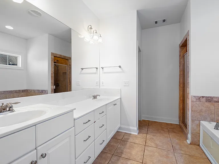 A double vanity in the primary bath offers ample storage.