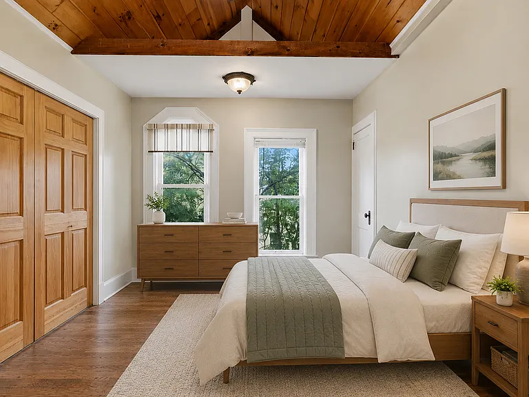 Virtually Staged. Bedroom two features vaulted ceilings, floor to ceiling windows, hardwood floors and plenty of room for everything you need to make this space your own.