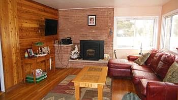 Gleaming wood floors and knotty pine accent walls along with the brick fire place mean this will probably become your favorite room.  The Pellet stove was added in 2010 and does a great job of heating most of the home.