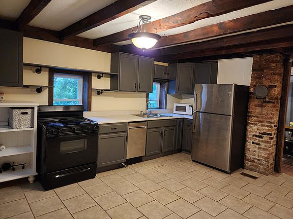 Large kitchen with refrigerator, new dishwasher, stove/ oven, microwave, washer& dryer hookups are off the kitchen area.