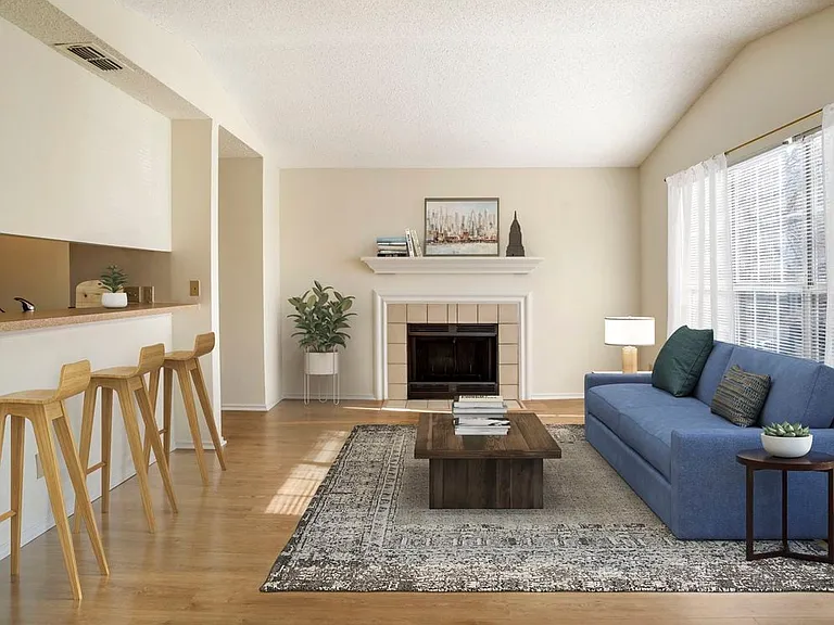 Renovated Package I kitchen and living area with hard surface flooring in common areas
