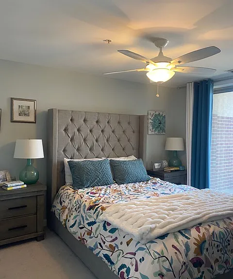 Same bedroom, shown with queen bed & nightstands