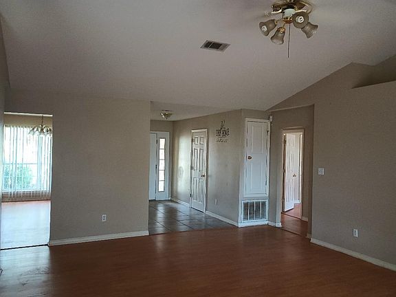 tiled entry, dining room to the left, hallway to bedrooms 1, 2 and 3 to the right