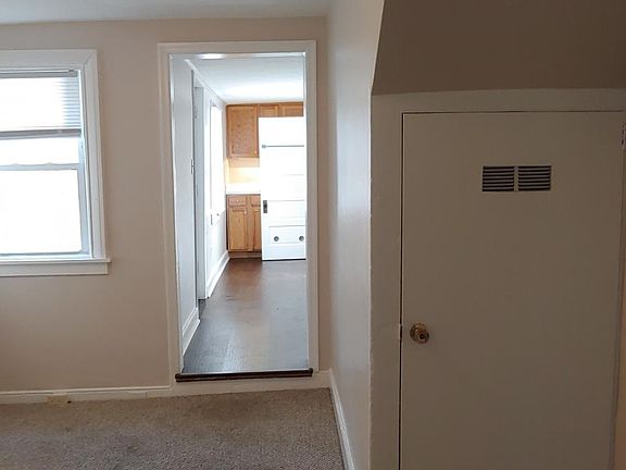 first floor dining room showing basement door (right) and kitchen in the background.
