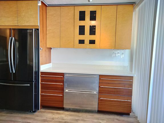 Entertainment center includes wine rack and extra freezer, plus assorted cocktail glasses.