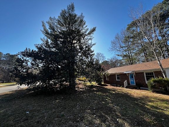 There is a beautiful huge magnolia tree in the front yard.