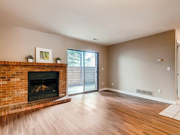 Hardwood floors and log fireplace with large walk out patio.