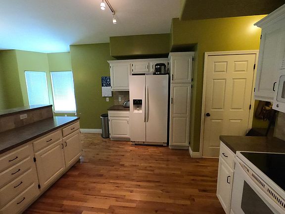 Kitchen includes microwave, refrigerator, stove.
