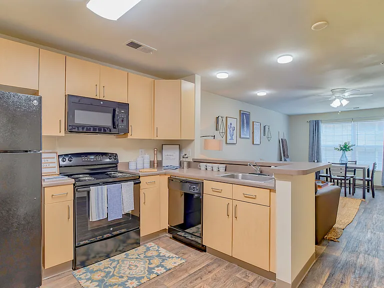 Cook in style with kitchens featuring wood cabinetry and all appliances included, professionally operated by Highlands Vista Group.