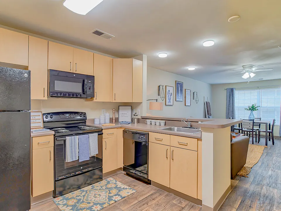 Cook in style with kitchens featuring wood cabinetry and all appliances included, professionally operated by Highlands Vista Group.