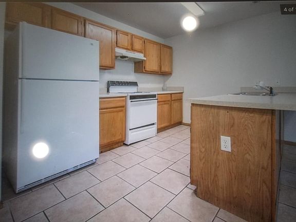 Kitchen showing breakfast bar on right.