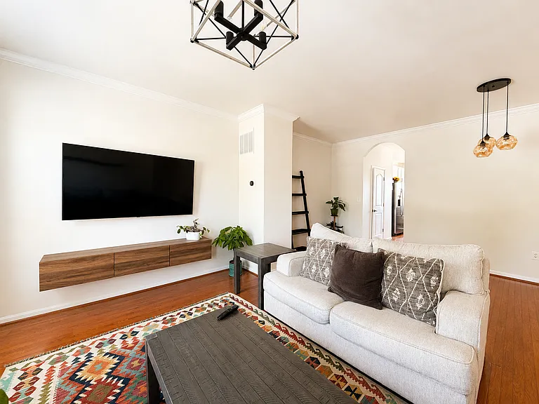 Bright Living Room with Large TV and Comfortable Seating