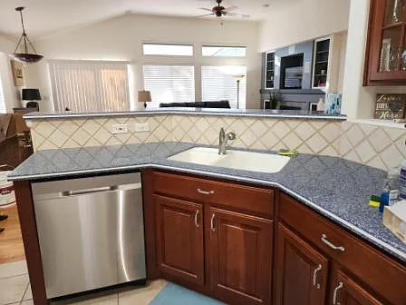 Kitchen with ample cunters, pantry, new appliances with corian counters and an eat at bar.