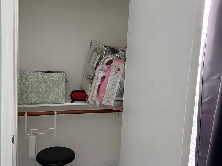 Closet with extra blankets with full-size bedroom