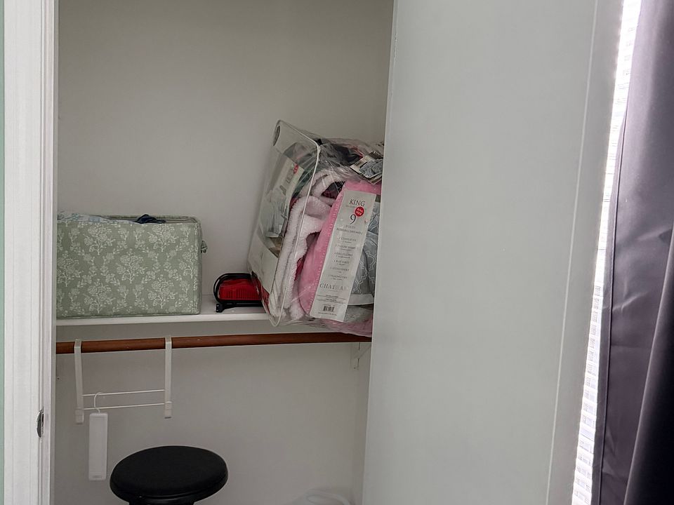 Closet with extra blankets with full-size bedroom
