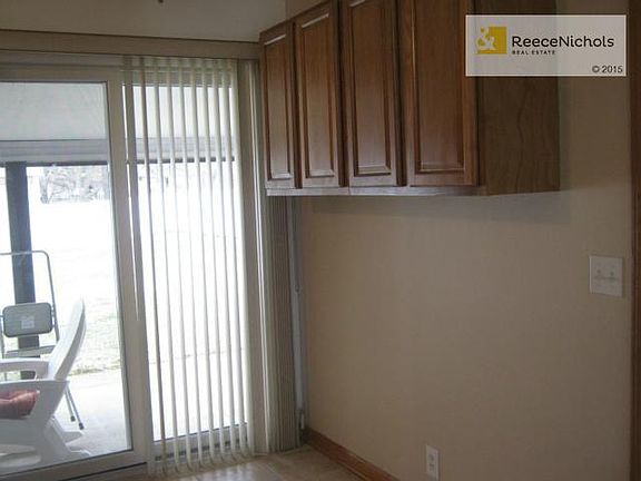 The eating area off the kitchen has cabinets for storage and wal