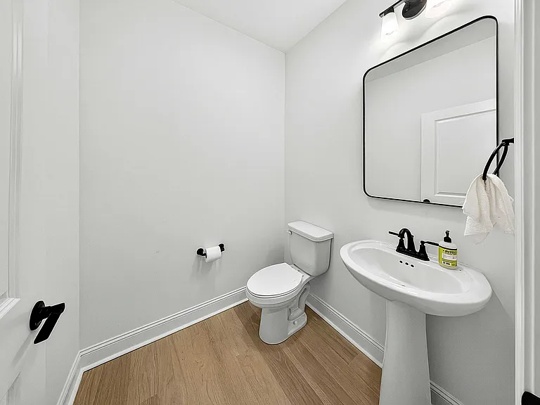 Powder room on main level with black bath accessories