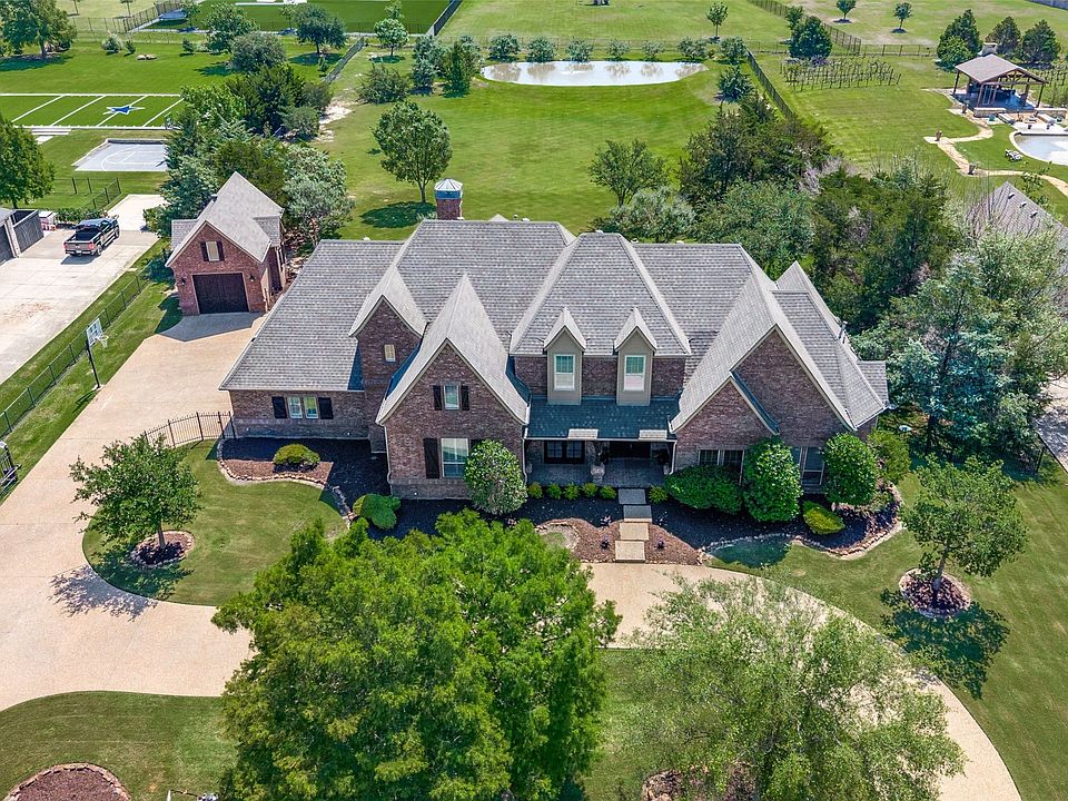This lot comes with everything you could want and MORE! Basketball goal, paved circle drive, pond in the back and beautiful trees throughout the property!