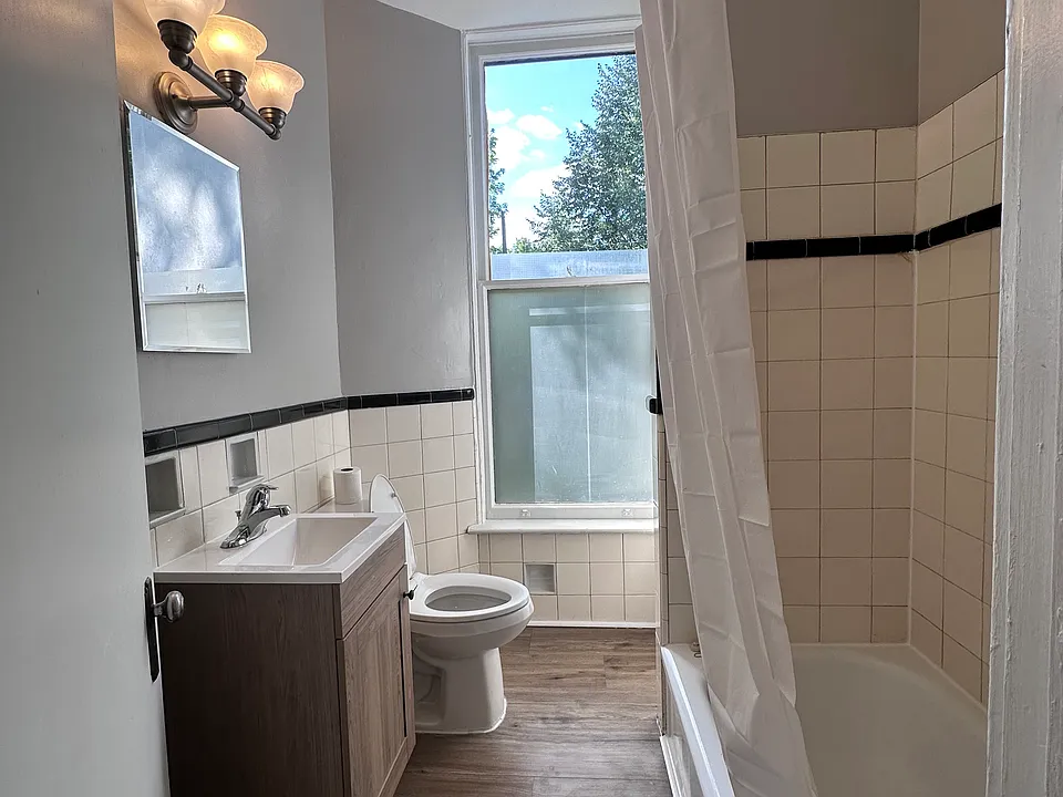 bathroom with bath/shower, vanity, medicine cabinet and storage closet