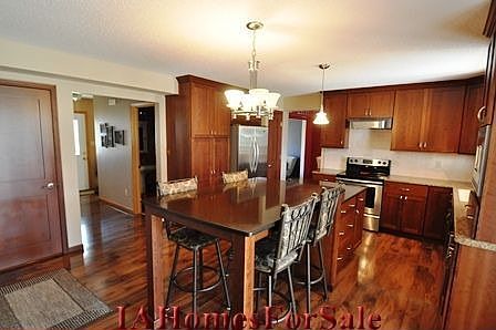 Kitchen - custom cherry cabinets with undercabinet lighting, quartz countertop, stainless steel appliances