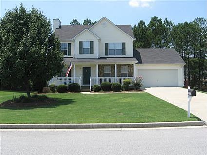 Two story home with rocking chair front porch