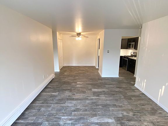 Spacious living room and dining area next to kitchen