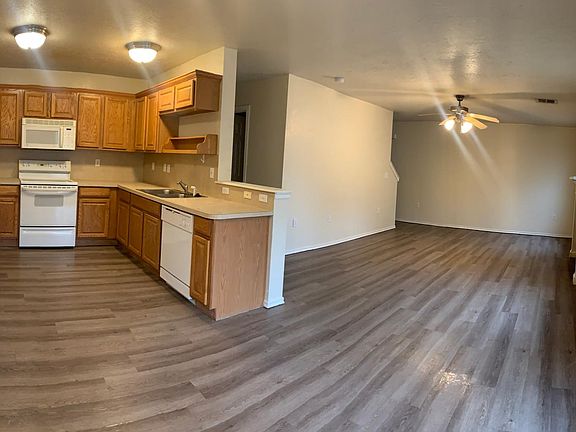 Panoramic of kitchen, dining room, and living room