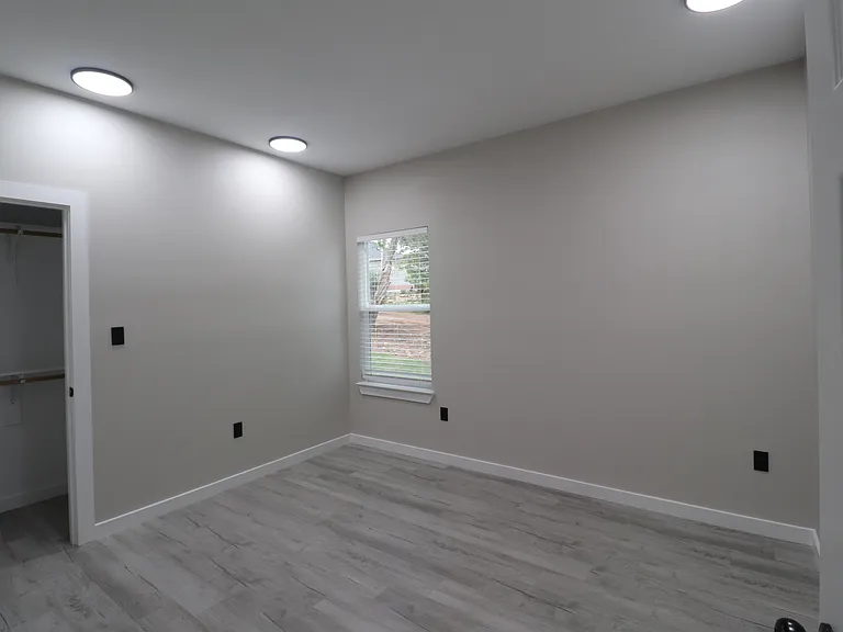 Bedroom 1 of 4 featuring modern flooring, recessed lighting, natural light, and a spacious closet.