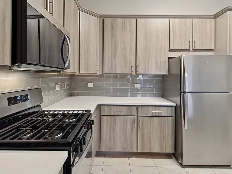 Full kitchen with stainless appliances and tile floors