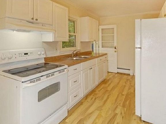Generous well maintained kitchen with plenty of cabinets for storage