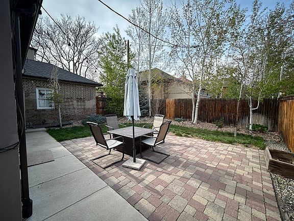 Current picture of backyard. Patio table is also a propane fireplace. Mature aspen trees in back.