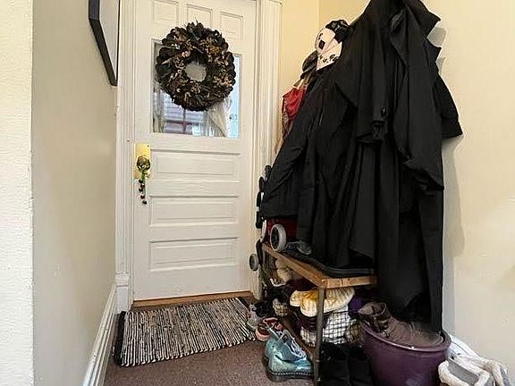 Spacious and utilitarian interior landing outside apartment door.